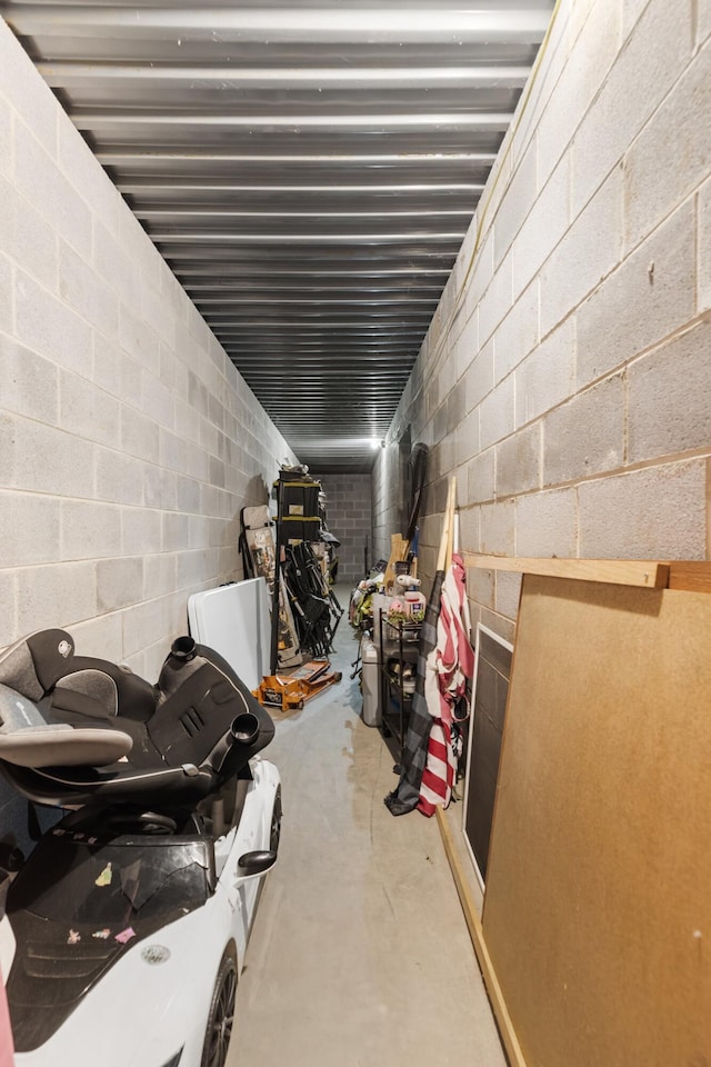 below grade area featuring concrete block wall