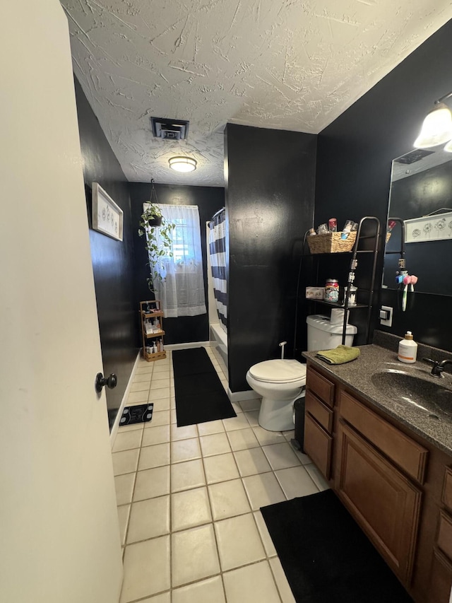 bathroom with tile patterned floors, visible vents, toilet, a textured ceiling, and vanity