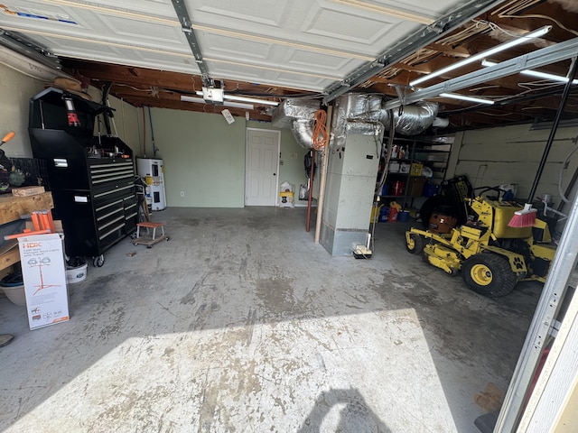 garage featuring heating unit and electric water heater