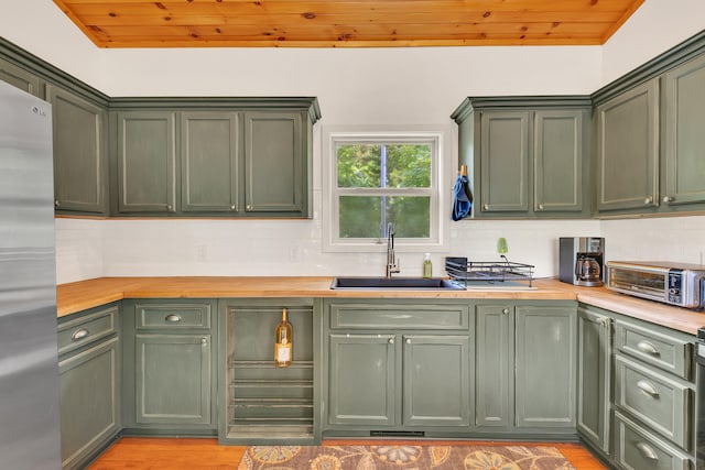 3466 Caywood Rd, Dandridge, TN 37725 - kitchen featuring green cabinetry, a sink, stainless steel refrigerator, and wood ceiling