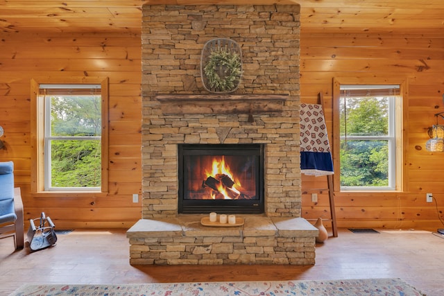 3466 Caywood Rd, Dandridge, TN 37725 - unfurnished living room with hardwood / wood-style flooring, wooden walls, plenty of natural light, and a stone fireplace