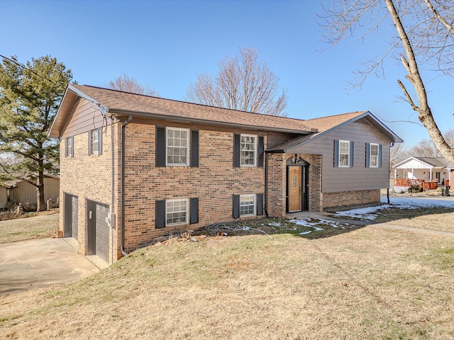 bi-level home featuring a front yard and a garage