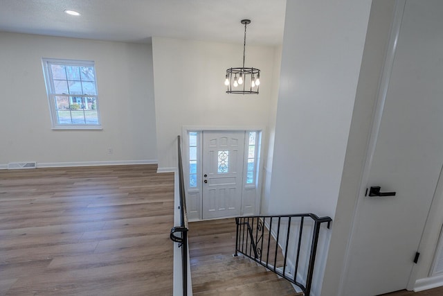 foyer with an inviting chandelier and light hardwood / wood-style floors