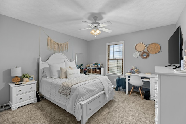 carpeted bedroom featuring a textured ceiling and ceiling fan