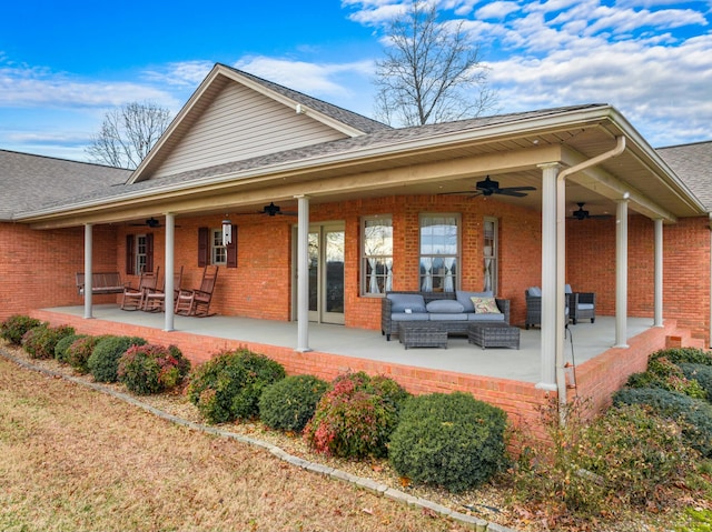 back of property featuring an outdoor living space and ceiling fan