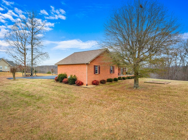 view of side of property featuring a yard