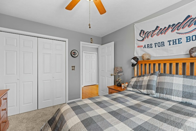 bedroom with ceiling fan, light carpet, and a closet