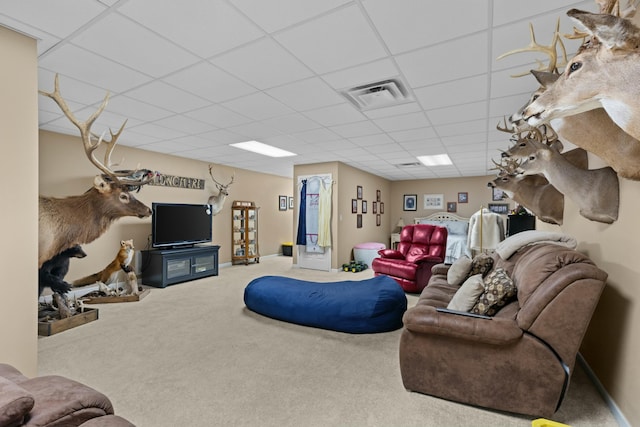 living room with carpet floors and a paneled ceiling