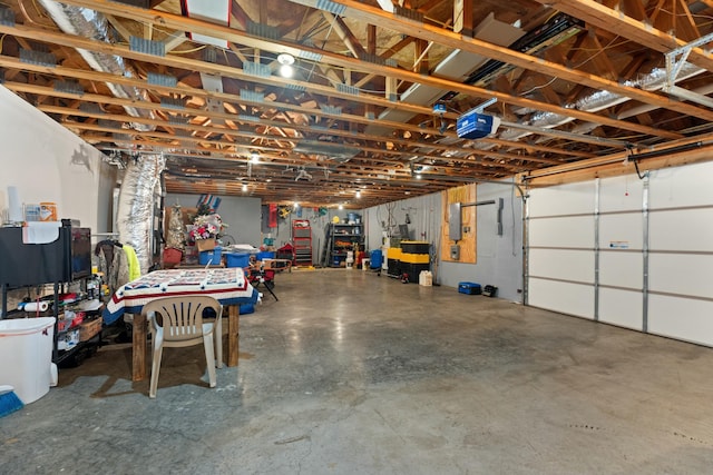 garage with a garage door opener and electric panel