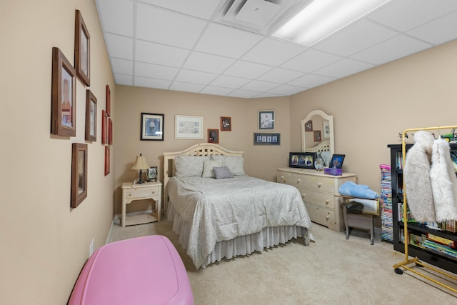 carpeted bedroom featuring a paneled ceiling