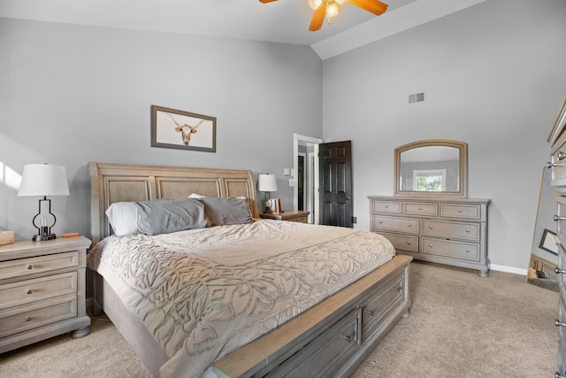 bedroom featuring visible vents, high vaulted ceiling, a ceiling fan, baseboards, and light colored carpet