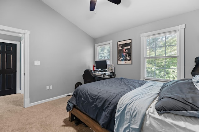 carpeted bedroom with a ceiling fan, baseboards, and vaulted ceiling