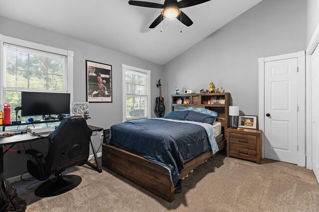 bedroom with carpet, ceiling fan, and vaulted ceiling