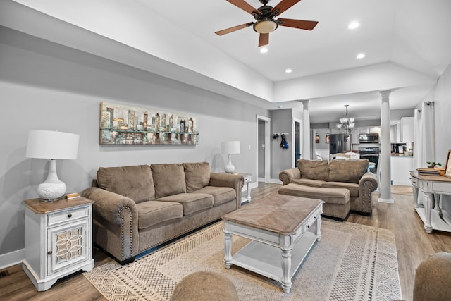 living room featuring recessed lighting, decorative columns, wood finished floors, and ceiling fan with notable chandelier