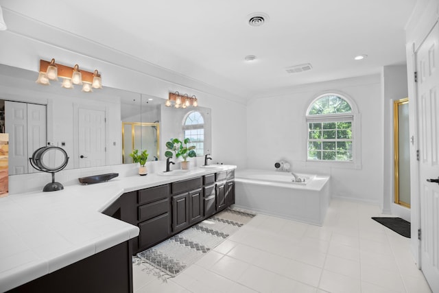 full bath with a wealth of natural light, visible vents, a shower stall, and a garden tub