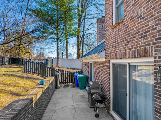 view of patio with area for grilling and fence