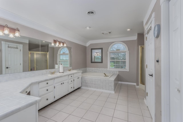 bathroom featuring a sink, a wealth of natural light, a shower stall, and tile patterned flooring