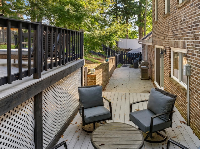 wooden terrace featuring area for grilling and fence