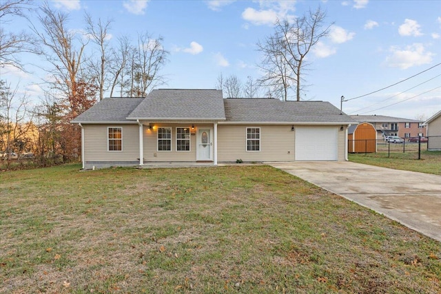 ranch-style house featuring a front lawn, fence, a garage, and driveway