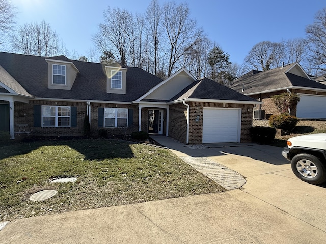 view of front of house featuring a garage, a front yard, and central air condition unit