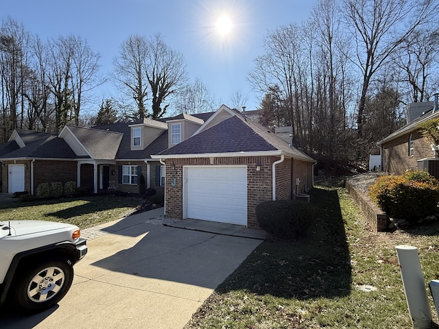 view of front of house with a garage, a front yard, and central AC unit