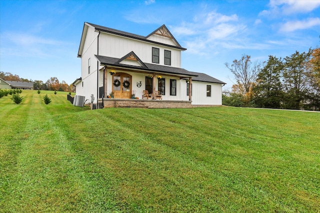 modern farmhouse featuring a porch, cooling unit, and a front yard