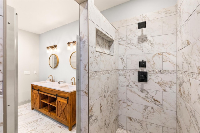 bathroom featuring a tile shower and vanity