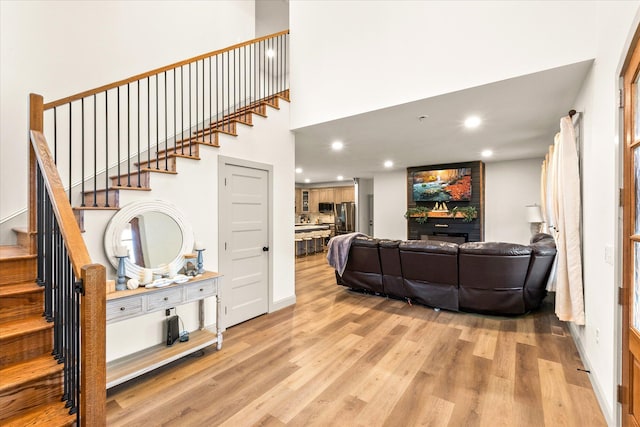 stairway with a large fireplace and hardwood / wood-style flooring