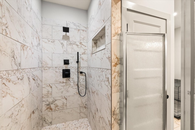 bathroom with tiled shower