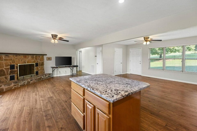 kitchen featuring dark wood-type flooring, a ceiling fan, and open floor plan
