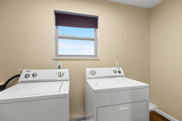 washroom with washer and clothes dryer, baseboards, and laundry area