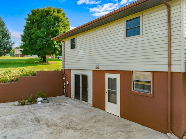 back of house featuring a lawn, fence, and a patio