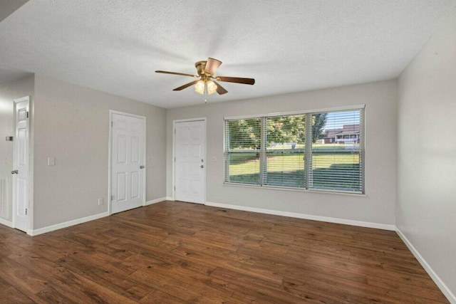 unfurnished room featuring baseboards, a textured ceiling, wood finished floors, and a ceiling fan