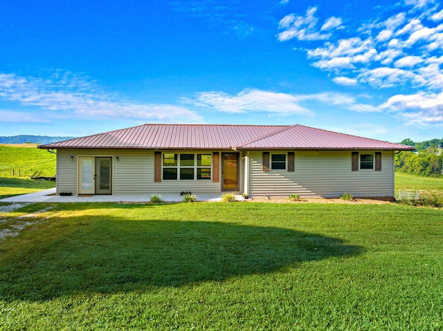 ranch-style house with a front yard and metal roof
