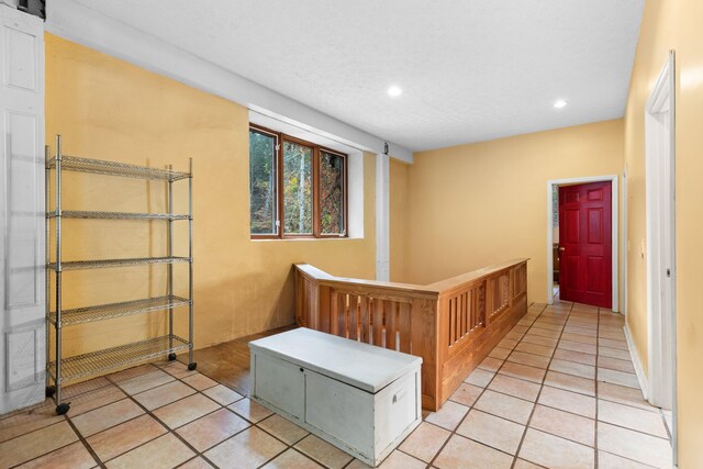 hall featuring light tile patterned floors