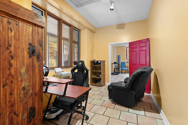 tiled office space featuring a textured ceiling