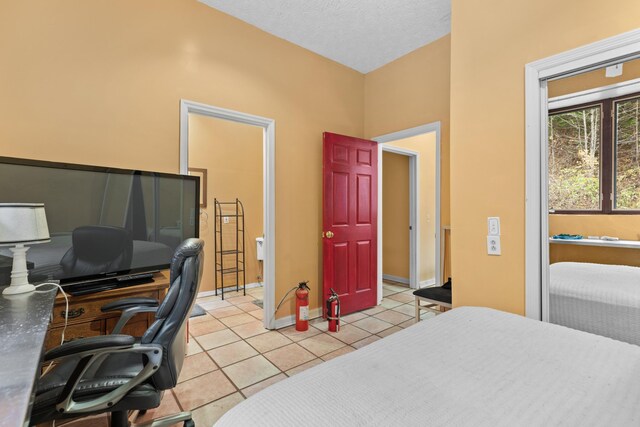 tiled bedroom featuring a textured ceiling