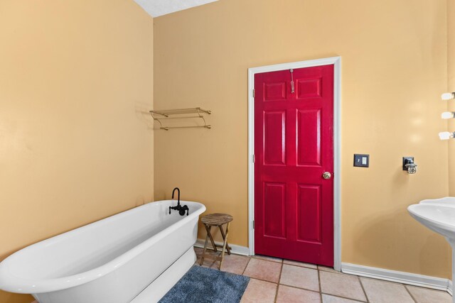 bathroom featuring tile patterned floors and a bathtub