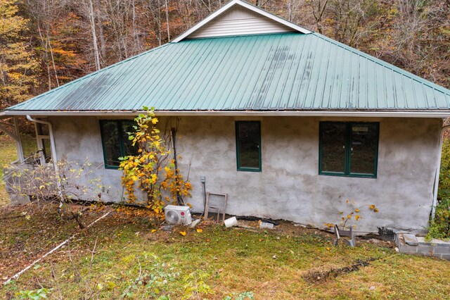 view of side of home featuring a lawn