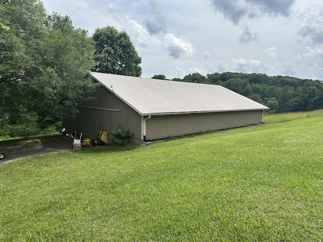 3041 Wineberry Ln, Morristown, TN 37814 - view of home's exterior featuring an outbuilding, a lawn, and metal roof