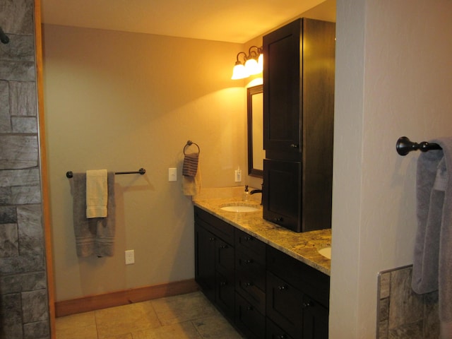 3041 Wineberry Ln, Morristown, TN 37814 - bathroom featuring double vanity, tile patterned flooring, baseboards, and tiled shower