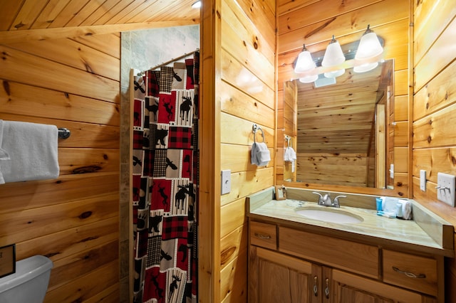 bathroom featuring wood ceiling, vanity, toilet, wood walls, and vaulted ceiling