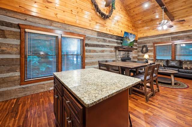 kitchen with wood ceiling, wooden walls, dark brown cabinetry, a kitchen island, and dark wood-type flooring