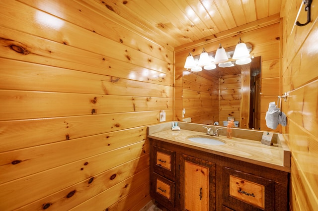 bathroom featuring wooden ceiling, vanity, and wood walls