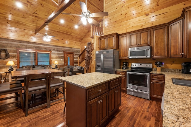 kitchen with appliances with stainless steel finishes, beam ceiling, light stone countertops, wood ceiling, and high vaulted ceiling