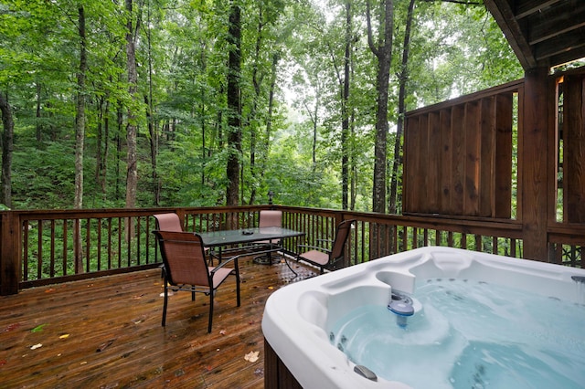 wooden deck with a hot tub