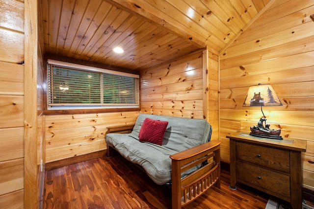 sitting room featuring vaulted ceiling, wood walls, dark wood-type flooring, and wooden ceiling