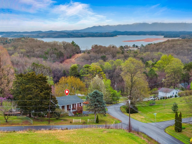 birds eye view of property with a water and mountain view