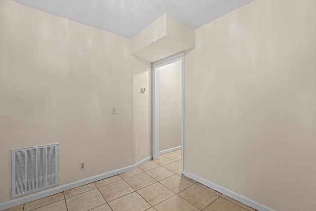 unfurnished room with light tile patterned floors, baseboards, and visible vents