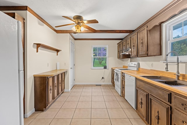 kitchen with white appliances, under cabinet range hood, light tile patterned flooring, a sink, and ceiling fan